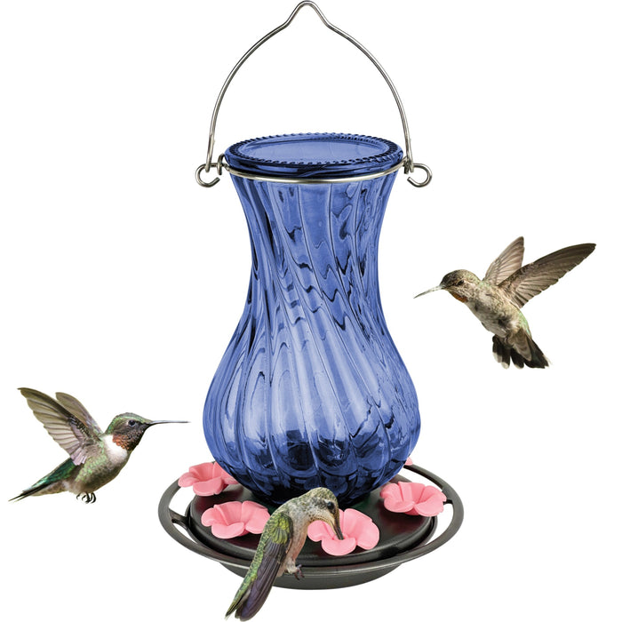 Blue glass hummingbird feeder with pink flowers and three hummingbirds on a white background