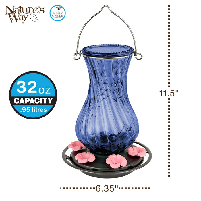 Blue glass hummingbird feeder with pink flowers on a white background, featuring 'Nature's Way' branding.