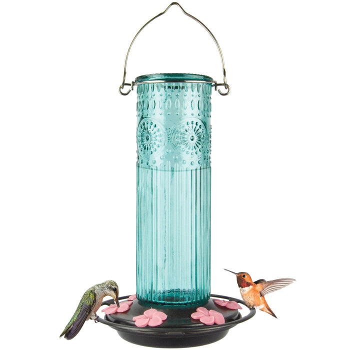 Blue glass hummingbird feeder with pink flowers and two hummingbirds on a white background