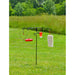 Bird feeder stand with multiple bird feeders on a grassy field