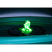 Green glowing object floating on water with a dark background
