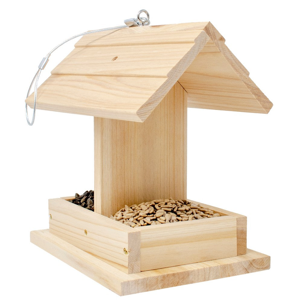 Wooden bird feeder with seeds on a white background