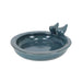 Blue ceramic bird bath with two birds on a white background