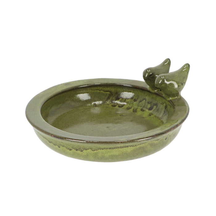 Green ceramic bird bath with two birds on a white background