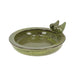 Green ceramic bird bath with two birds on a white background
