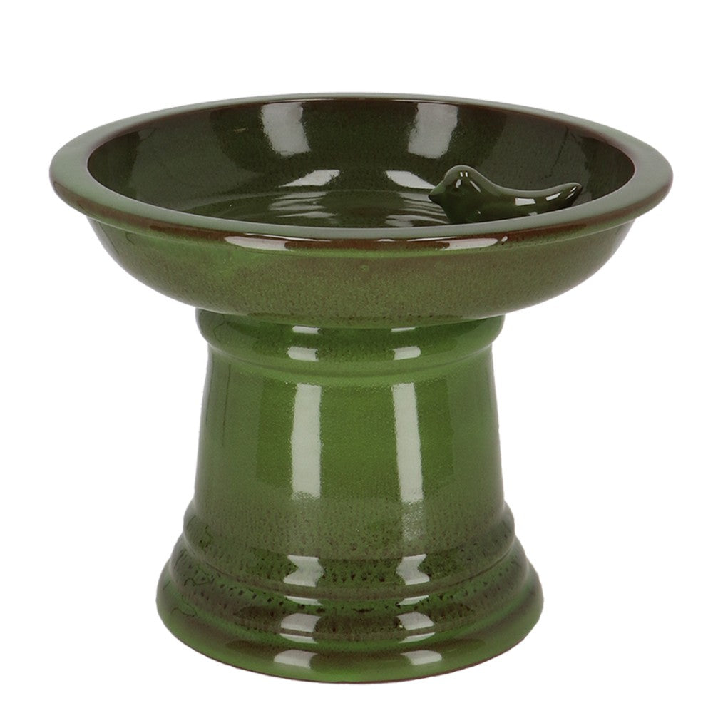Green ceramic bird bath on a white background