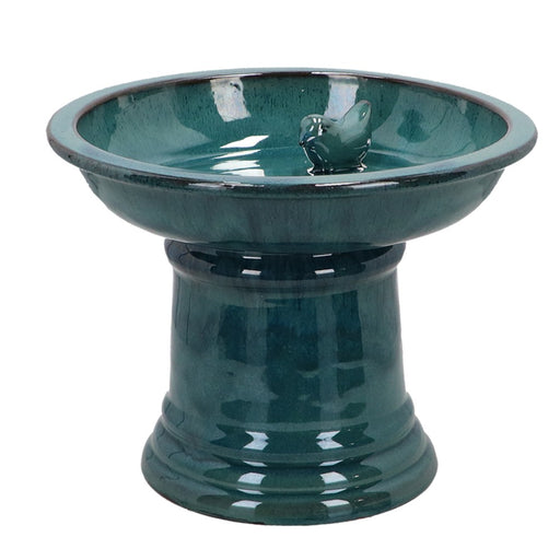 Green ceramic bird bath on a white background