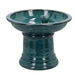 Green ceramic bird bath on a white background