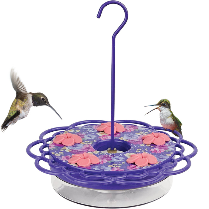 Hummingbird feeder with floral design and two hummingbirds on a white background