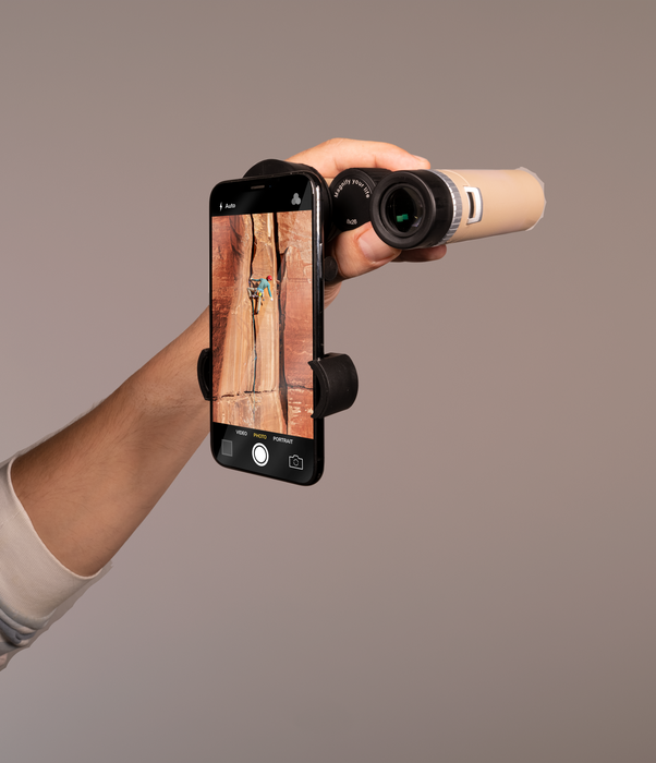 Hand holding a smartphone with a camera app open, displaying an image of a wooden surface.