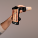 Hand holding a smartphone with a camera app open, displaying an image of a wooden surface.