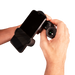 Hand holding a smartphone with a black phone holder against a white background