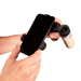 Hand holding a smartphone with a phone holder attached, using a binocular attachment on a white background
