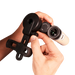 Hand holding a pair of binoculars with a white background