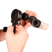 Hand holding a pair of binoculars with a white background