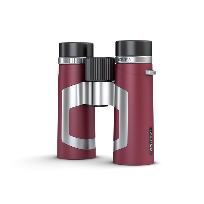 Red binoculars with silver and black accents on a white background