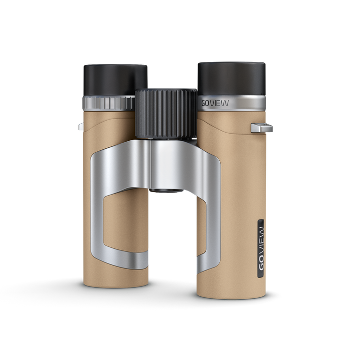 Binoculars with beige body and black and silver accents on a white background