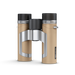 Binoculars with beige body and black and silver accents on a white background