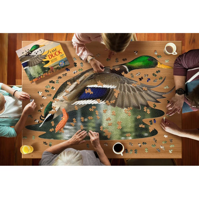 People working on a duck-themed puzzle at a wooden table.