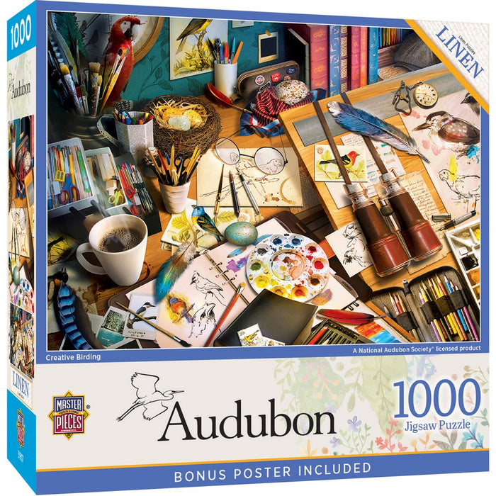 Audubon 1000-piece puzzle box with art supplies and coffee on a desk