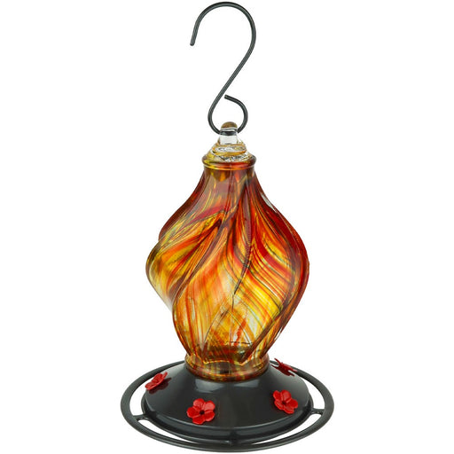 Glass hummingbird feeder with orange and yellow swirls on a white background