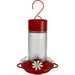 Red and clear hummingbird feeder on a white background