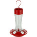 Hummingbird feeder with red top and base on a white background
