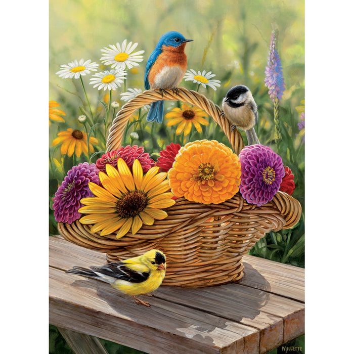 Basket of flowers with colorful birds on a wooden surface
