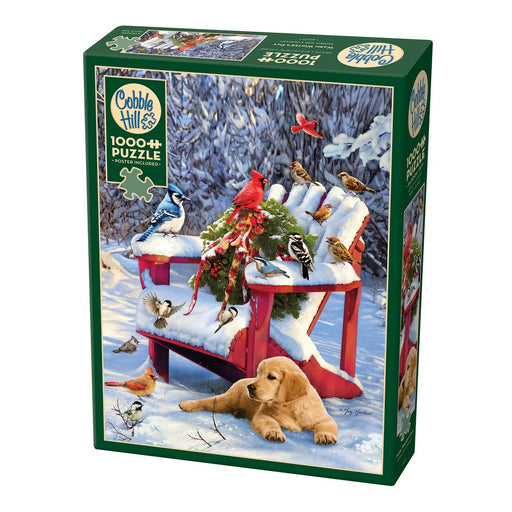 Jigsaw puzzle box with a winter scene featuring a dog, birds, and a red chair.