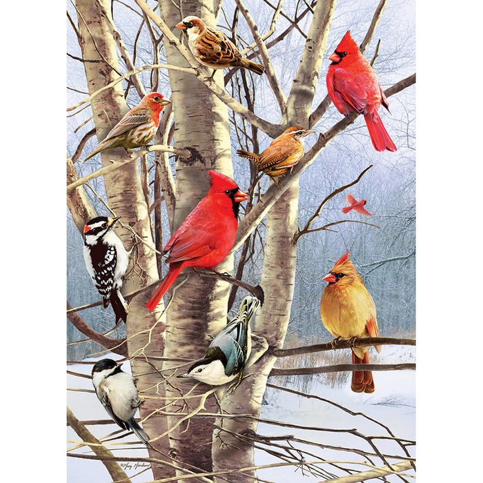 Birds perched on a tree in a snowy landscape