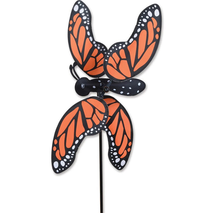 Butterfly-shaped wind spinner with orange, black, and white wings on a white background