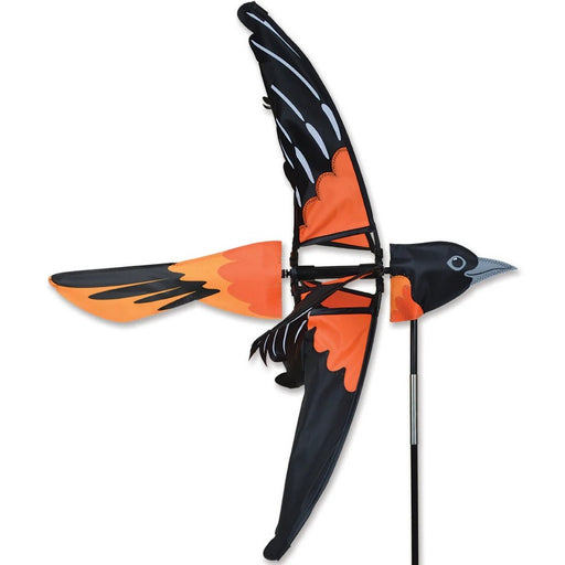 Black and orange bird-shaped kite on a white background