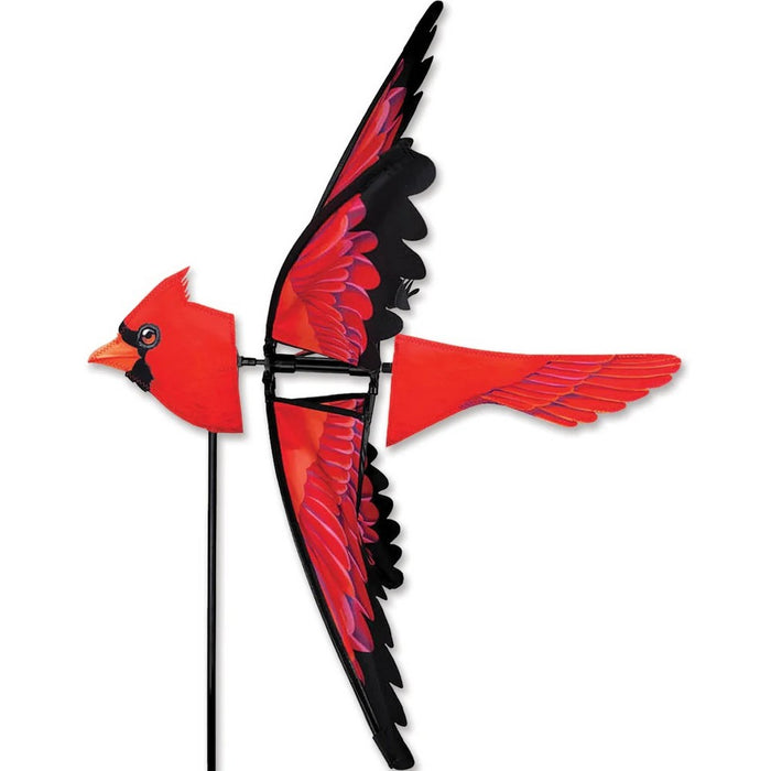 Cardinal-shaped kite with red and black design on a white background