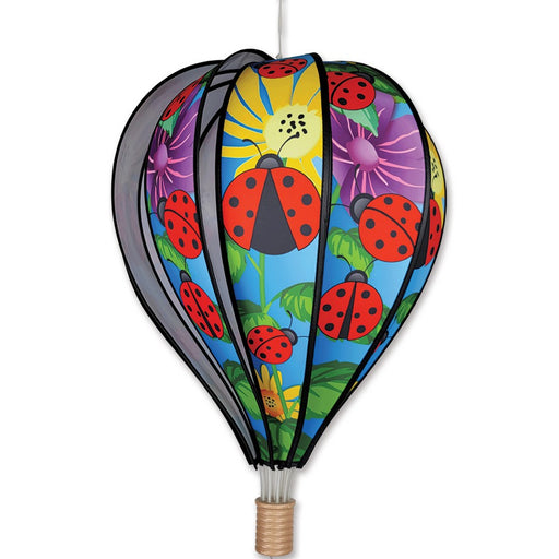 Colorful hot air balloon-shaped kite with ladybug design on a white background