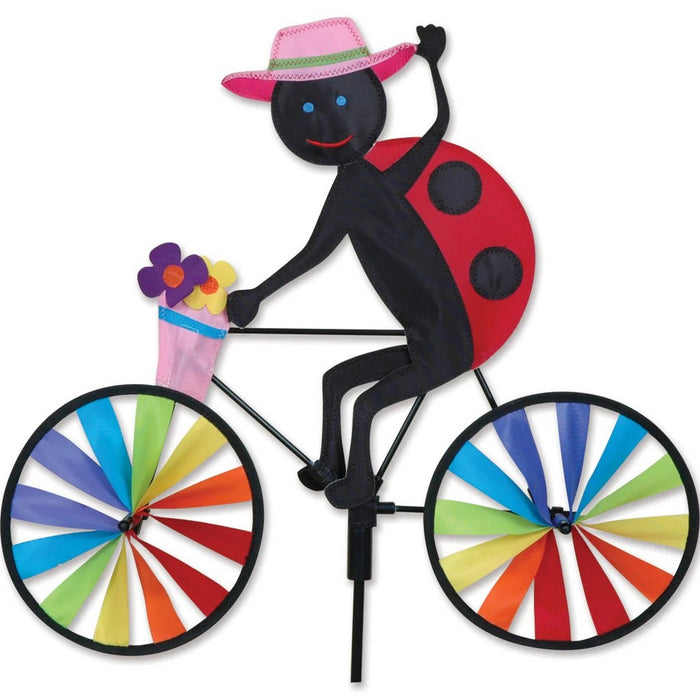Colorful ladybug windmill with a rainbow bicycle design on a white background