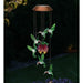 Solar-powered hummingbird and flower mobile with glowing effect on a dark background