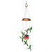 Decorative hanging wind chime with hummingbirds and flowers on a white background