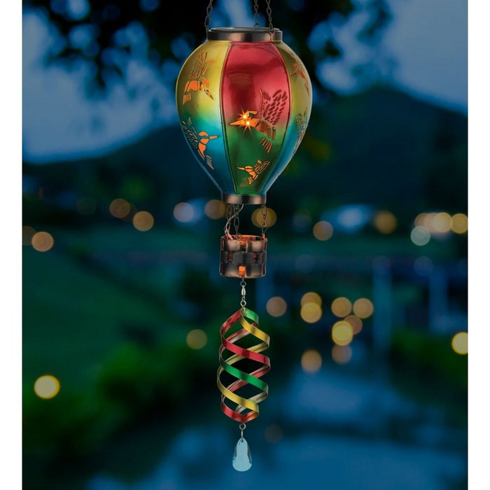 Colorful hanging lantern with a spiral design against a blurred outdoor background
