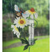 Decorative rain gauge with flowers and a bee on a rainy day background