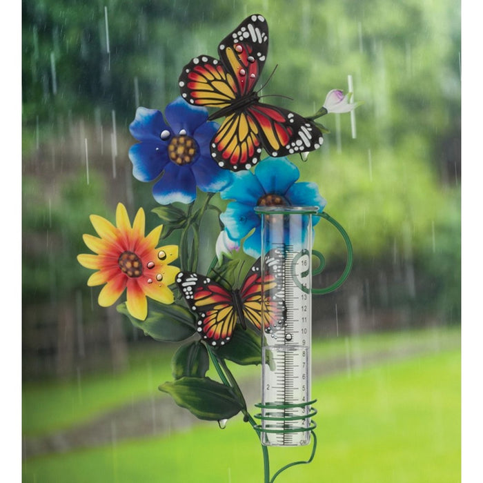 Decorative rain gauge with colorful flowers and butterflies on a rainy day background.