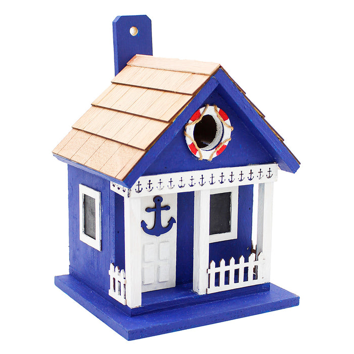 Blue and white birdhouse with nautical decorations on a white background
