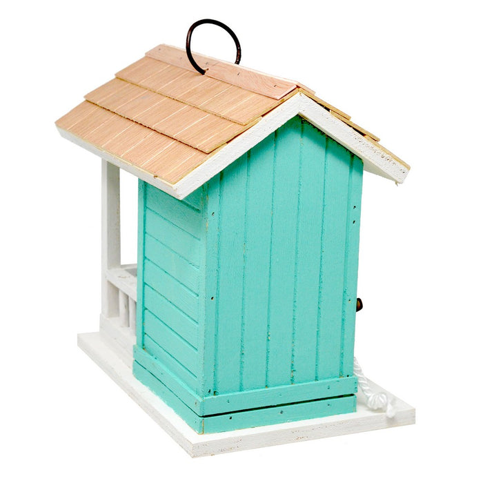 Turquoise birdhouse with a wooden roof on a white background