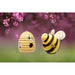 Hanging bee-shaped birdhouse and bee ornament with a blurred floral background