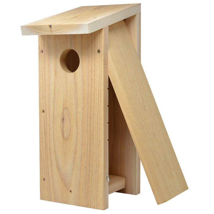 Wooden birdhouse with a triangular roof on a white background