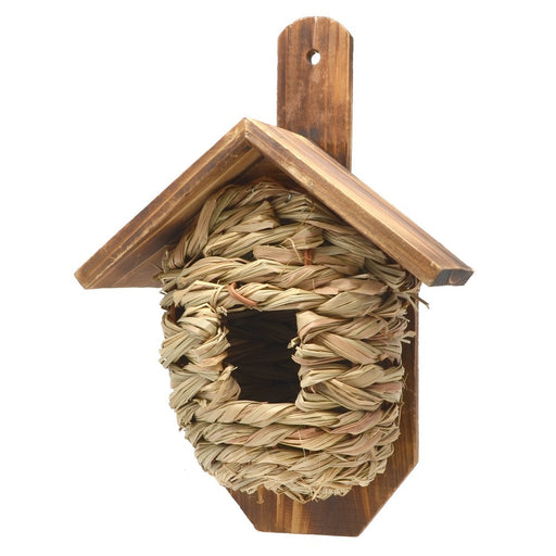 Wooden birdhouse with a woven straw nest on a white background