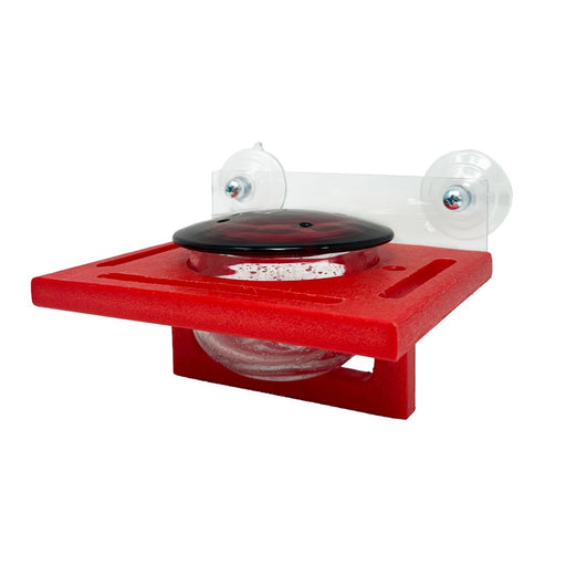 Red plastic device with a black component on a white background