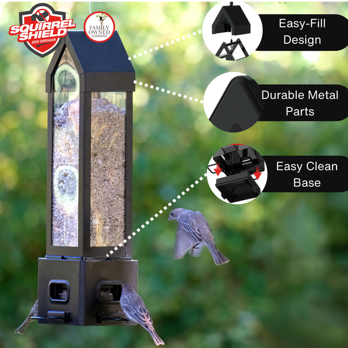 Bird feeder with features highlighted on a blurred green background