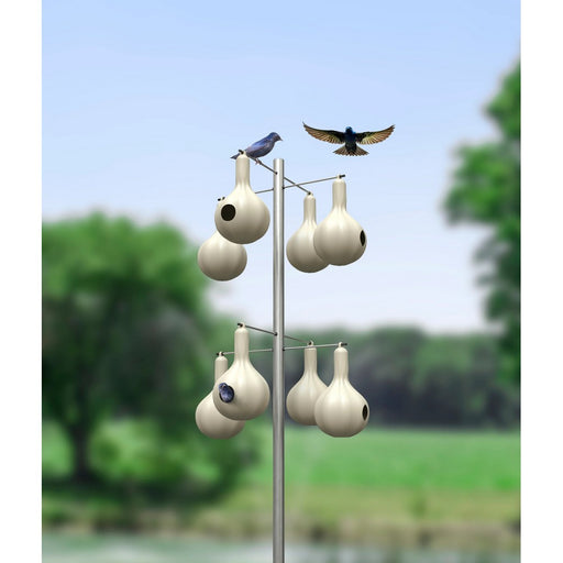 Birdhouse structure with multiple birdhouses and birds perched on a blurred natural background