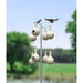 Birdhouse structure with multiple birdhouses and birds perched on a blurred natural background