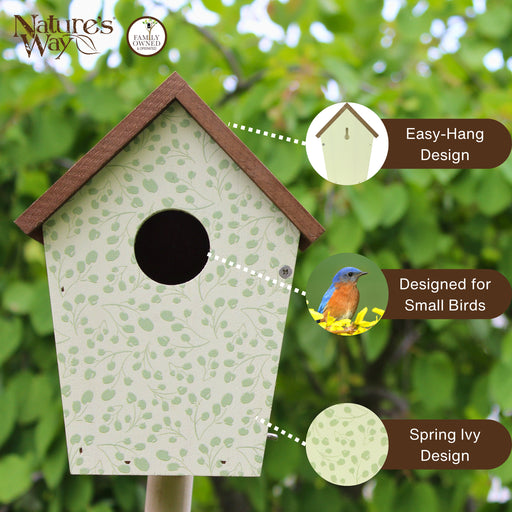 Birdhouse with green ivy design on a blurred natural background